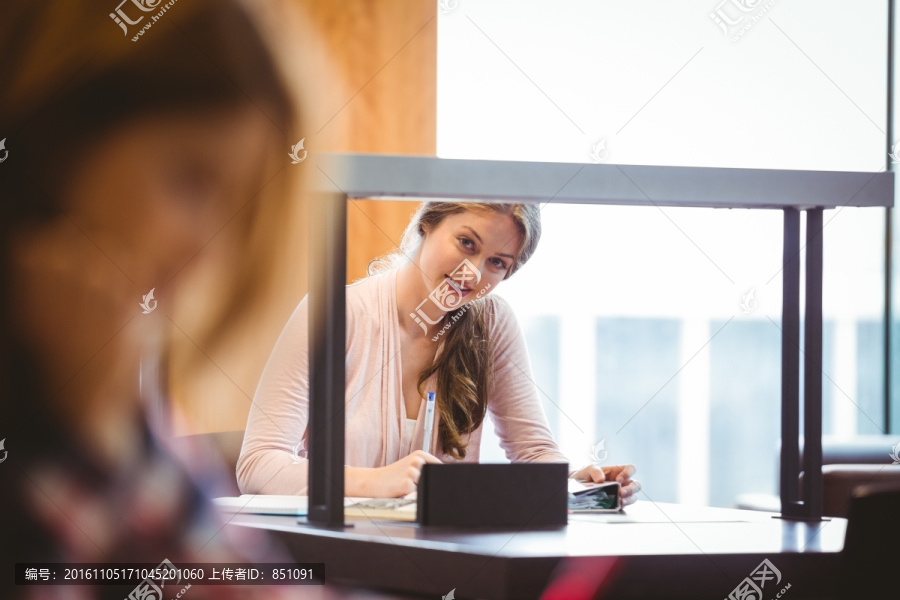 坐在窗户边做笔记女大学生