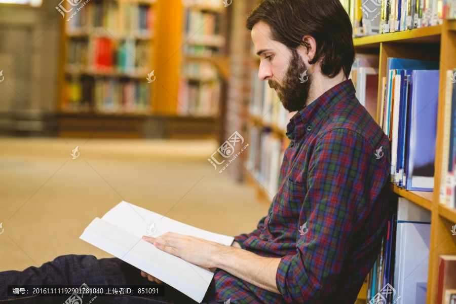 坐在图书馆地上看书的男人