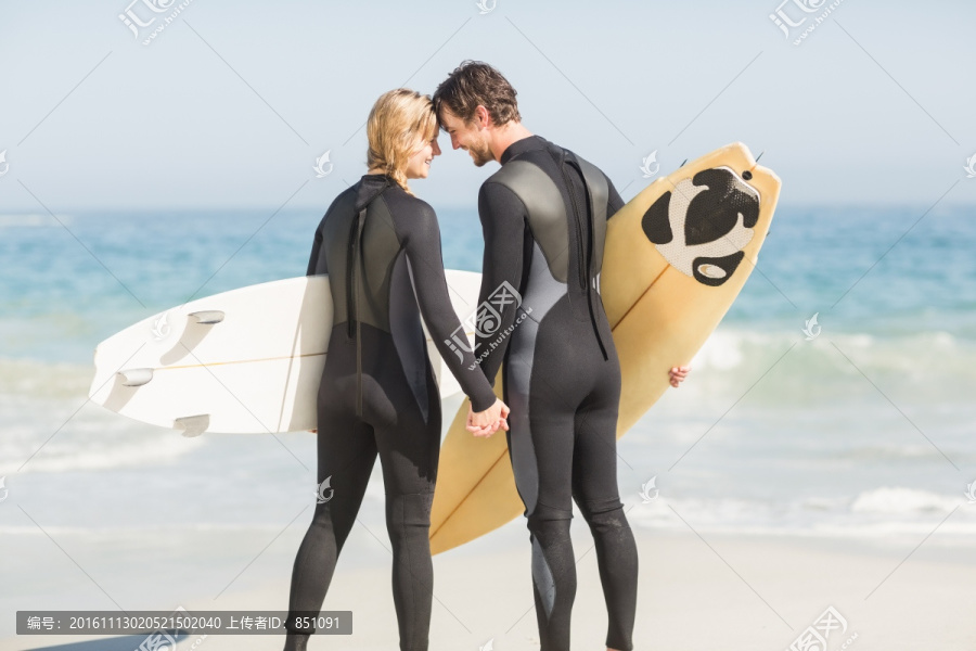 幸福的夫妇站在冲浪板头