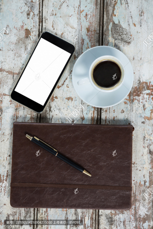 日记智能手机和桌上的咖啡杯