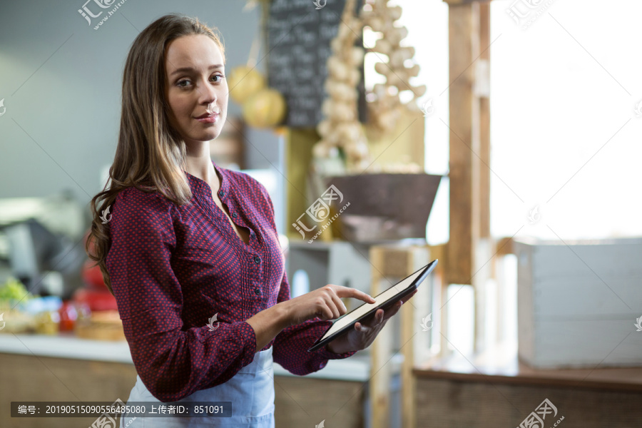 女性员工在烘焙店柜台使用电脑