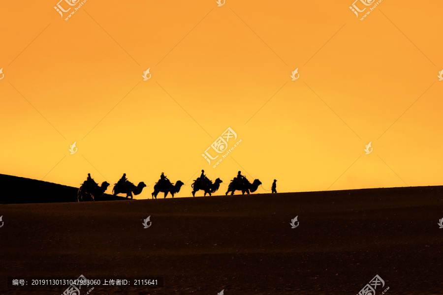 敦煌鸣沙山骑行骆驼队的剪影