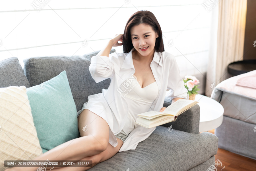 年轻女子在沙发上看书