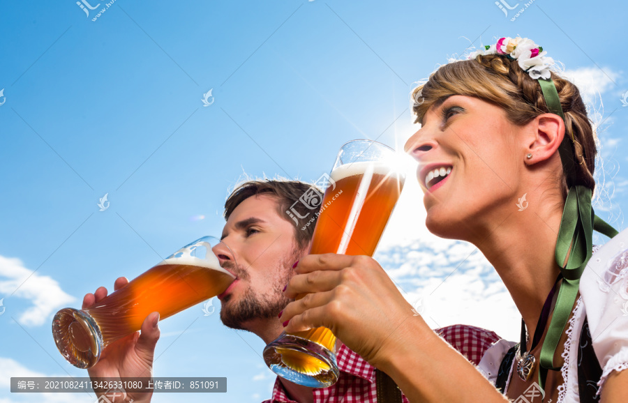 一对夫妇在阿尔卑斯山的小屋里喝着小麦啤酒