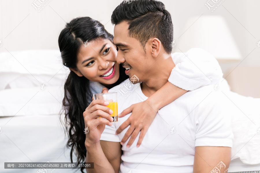 亚洲夫妇，男人和女人，在床上互相拥抱