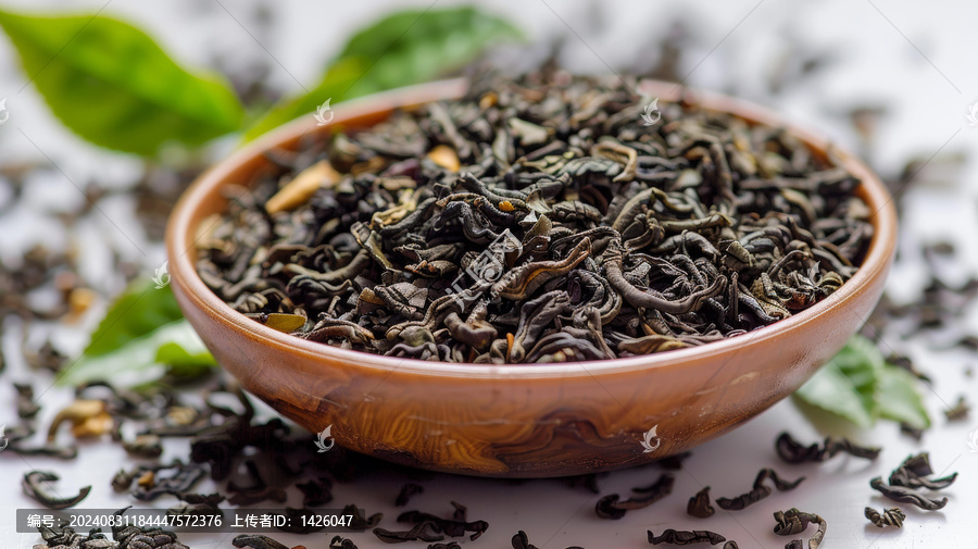 一碗烏龍茶葉和散落在白色表面上的烏龍茶葉