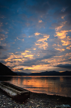 美丽夕阳湖岸边的小舟