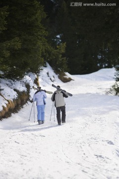 滑雪的夫妇沿着滑雪坡