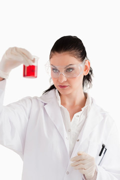女科学家在看烧杯中红色液体
