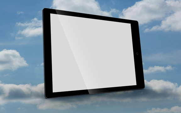 空白平板电脑摆着蓝天白云背景前
