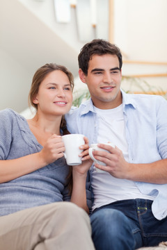 夫妻俩在客厅里喝茶的时候看电视
