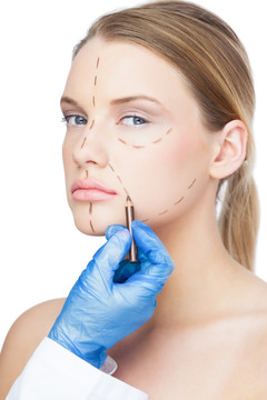 外科医生在女人脸上画虚线