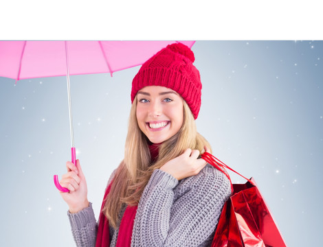 撑着伞拿着购物袋的女人