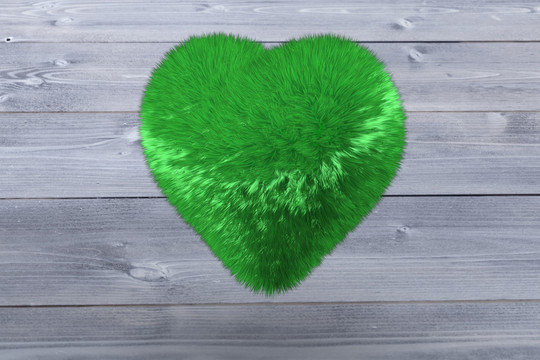绿色爱心在木板背景下