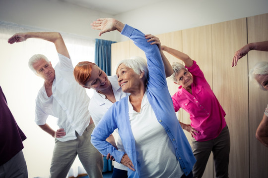 老年人们在健身房里做伸展运动