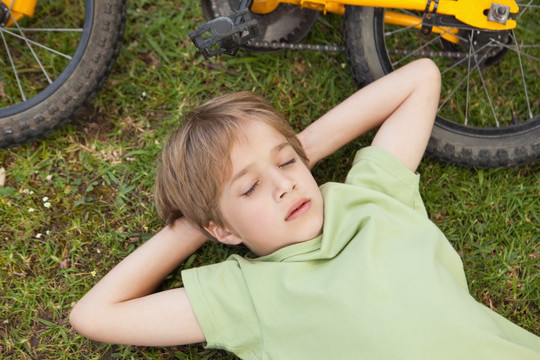 躺在草坪上休息的小男孩