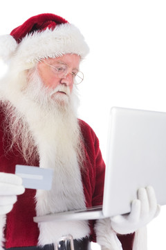 拿着笔记本电脑的圣诞老人