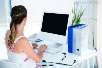 孕妇在她的电脑上打字