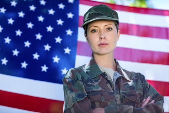 站在美国国旗前的女士兵