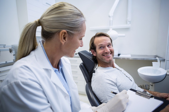 牙医微笑着和病人对话
