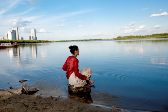湖边坐着的红衣女子