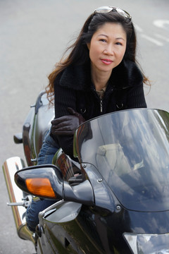 成熟的女人坐在摩托车上