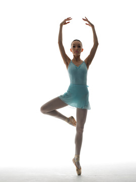 高举手臂单脚站立跳芭蕾的女人