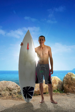 拿着冲浪板在沙滩上的男人