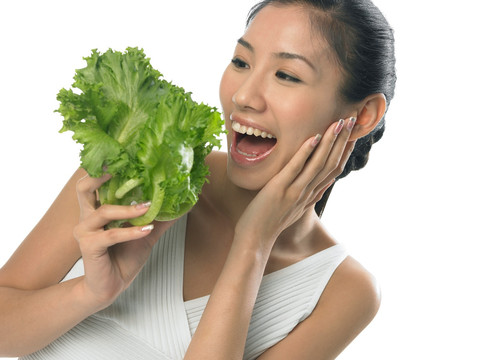 微笑着看着蔬菜的女人