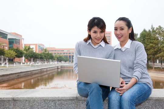 年轻大学生在校园里使用笔记本电脑