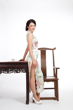 棚拍身穿中国传统服装的年轻女人和中式家具