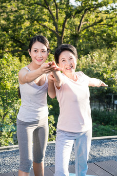 一个年轻女人在指导一个老年人锻炼身体