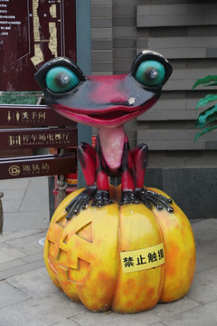 南瓜上的青蛙雕像