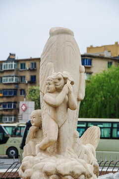 鲤鱼与男孩女孩前面雕塑