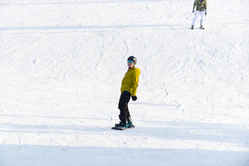 穿黄色滑雪服的单板运动员