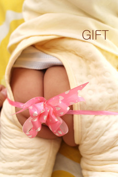 新生儿宝宝被礼物丝带缠绕