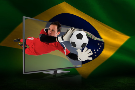 通过电视下巴西国旗的守门员救球