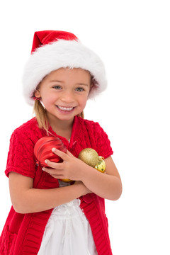 小女孩戴着圣诞帽拿着小饰品