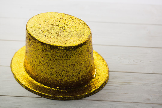木制桌子上的金色聚会帽