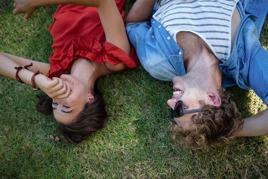 一对夫妇躺在公园的草地上
