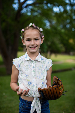 公园里拿棒球的可爱女孩的肖像