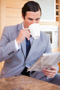 读新闻喝咖啡的年轻商人