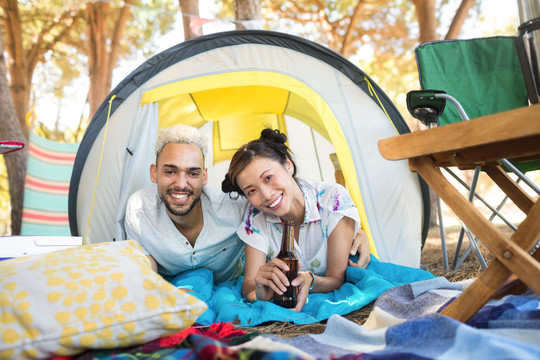 帐篷里放松的微笑夫妇的肖像