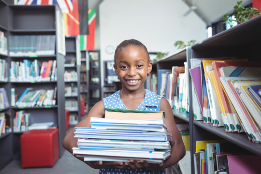 图书馆书架旁的微笑女孩