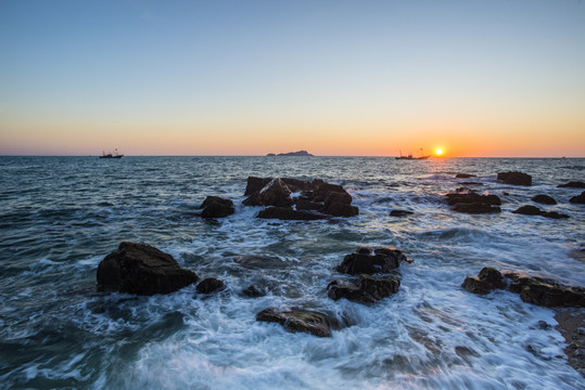 夕阳下渔船出海