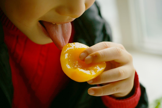 小孩吃黄桃的图片