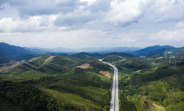 蓝天白云下穿过群山的高速公路