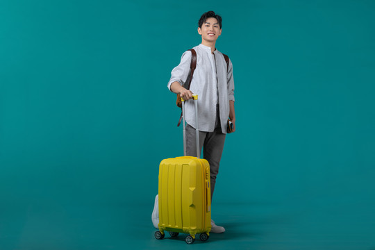 棚拍拿着行李箱的年轻男子