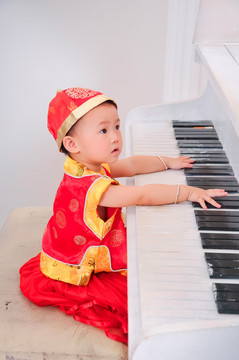 做在钢琴前面的小宝宝