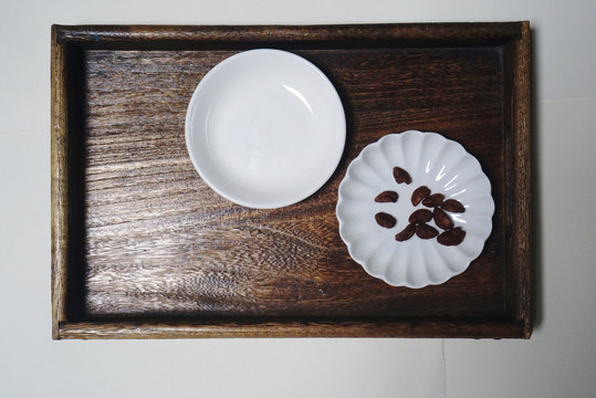 木制托盘上的圆碟和花瓣形碟子